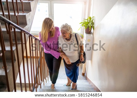 Caregiver helping senior woman climb staircase
 Royalty-Free Stock Photo #1815246854