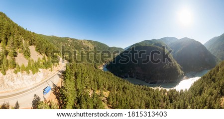 Beautiful Panoramic View of Canadian Nature and a Scenic Road, Trans-Canada Hwy, during sunny summer day. Aerial Drone Shot. Near Hells Gate, BC, Canada.