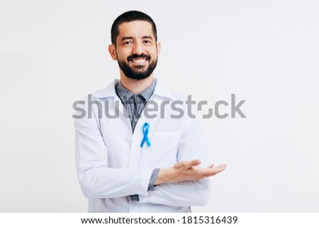 Prostate Cancer Awareness. Doctor man holding light Blue Ribbon for supporting people living and illness. Men Healthcare and World cancer day concept Royalty-Free Stock Photo #1815316439