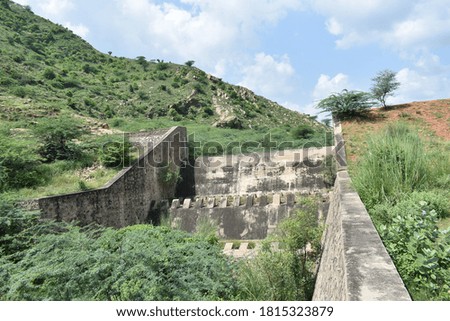 Old dam stone picture. Blue sky background.