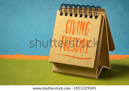 Giving Tuesday - handwriting in a spiral ketchbook against abstract paper landscape, charity and philantrophy concept Royalty-Free Stock Photo #1815329045