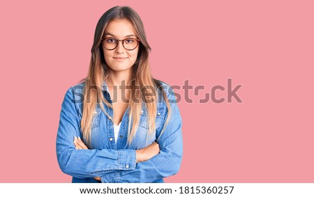 Beautiful caucasian woman wearing casual clothes and glasses smiling in love doing heart symbol shape with hands. romantic concept. 