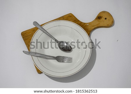cutlery in the form of spoons, forks and plates