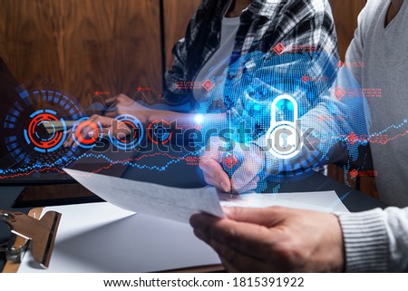 Man and woman working together on securitization of information of project. Blue icon infographic lock hologram. Concept of datum safety. Double exposure.