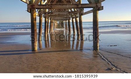 Relaxing view of the underneath of Cherry Grove pier during a sunny day, South Carolina