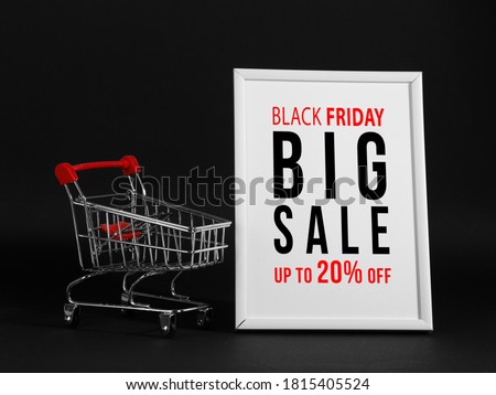 The concept black friday, the advertising frame and the shopping trolley on black background, buisiness promotional mockup.