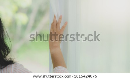 Woman looking through the window