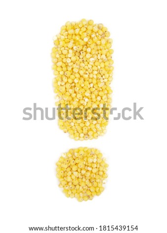 Exclamation mark from grain of millet on isolated white background.