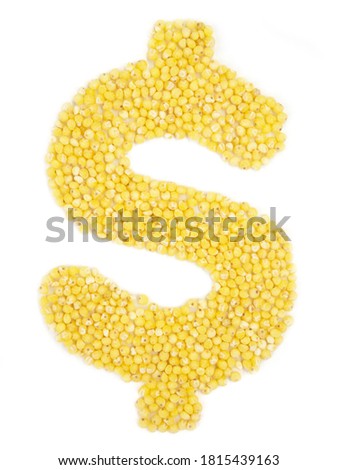 Dollar sign from grain of millet on isolated white background.