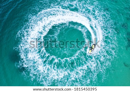People are playing a jet ski in the sea.Aerial view. Top view.amazing nature background. The color of the water and beautifully bright. 
