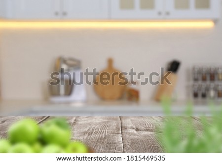 Wooden table in light kitchen. Space for design
