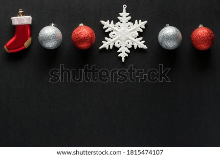 Christmas decorations on black background. New year and Christmas holiday concept. Flat lay  on black paper background with empty space for text