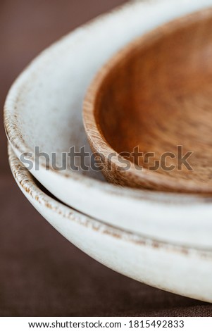 Macro abstract photography of modern minimalist ceramics set and wooden bowl. 