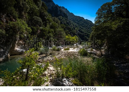 Closeup of river scenes in forest in Epirus Greece. Small river enveloped with rocks.