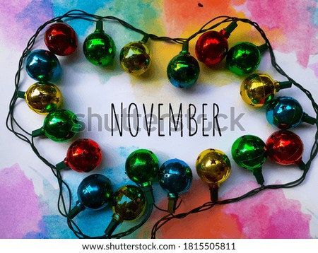 Abstract November Greeting Text On Colorful Background With Colorful Light Bulbs Frame Stock Photo