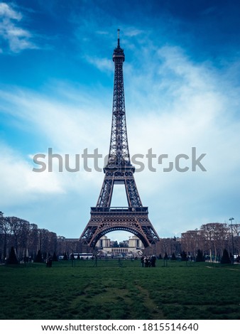 A beautiful vertical shot of the Eiffel Tower on a bright blue sky background