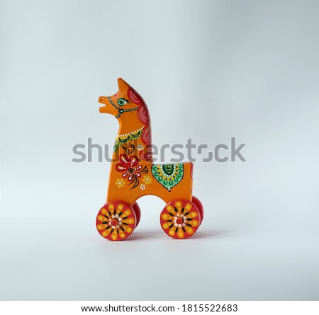 Hand-painted wooden horse on wheels.