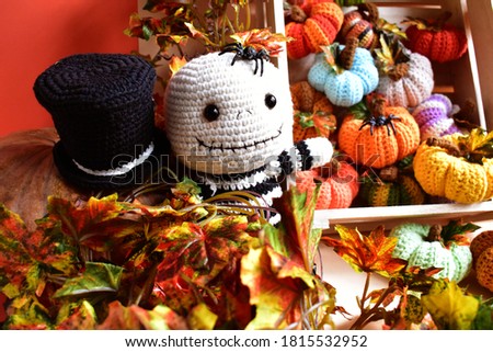 Halloween crochet with cute ghost, pumpkins, spiders, witch hat, knitting, handmade, kid, childhood, children, funny, toys in orange/ autumn leaves background
