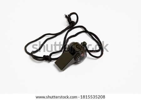 Black sport whistle isolated on white background.High resolution photo.