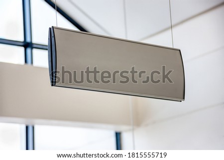 empty signboard hanging on modern white walls