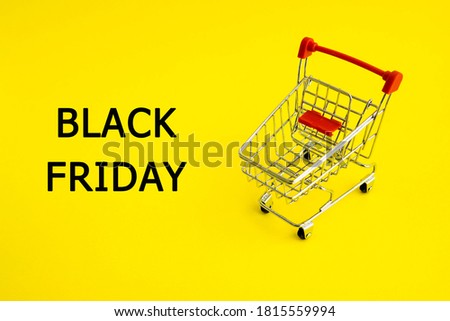 shopping cart and the words black Friday on a yellow background. Theme of purchases and sales.