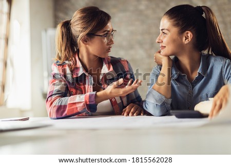 Young creative women communicating while planning a new business  in the office