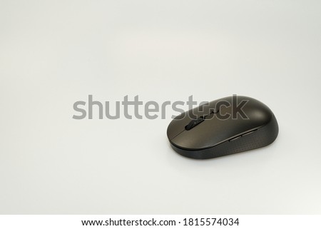 Black modern wireless pc mouse on white background. top view, selective focus