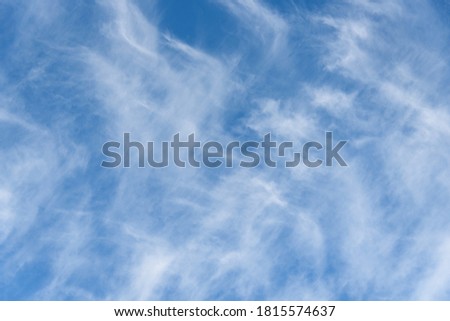 Fresh air, bright blue sky with wispy white clouds, as a nature background
