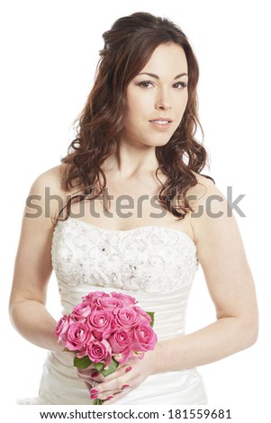 Female bride holding a wedding bouquet of pink roses on white background smiling