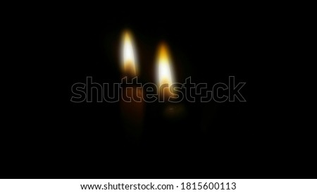 Blurred picture of two candle lights with dark background