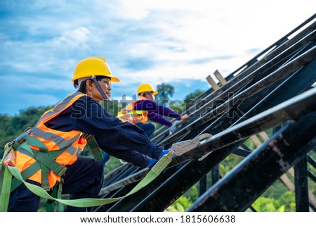 Engineer wearing safety harness and safety line working at high place at construction sites,Engineering tools and construction concept.