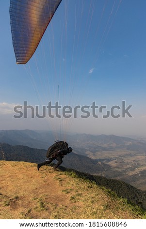 
Man paragliding on a mountain in Brazil. Radical sport.