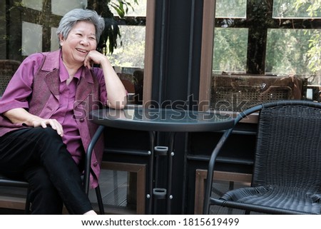 asian elder woman resting on terrace. elderly female relaxing on patio. senior leisure lifestyle at home