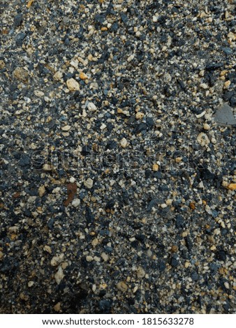 Sand with small rock and stone background texture closeup