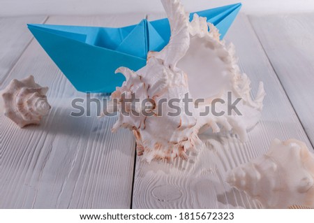 Paper blue ship and big shell