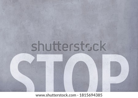A painted sign on concrete road, abstract background.