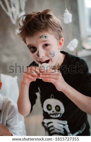 Kids eat Halloween sweets at a costume party