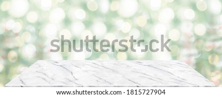 Perspective marble table with blur Christmas tree decorate string light .Panoramic banner mockup for product display greeting card