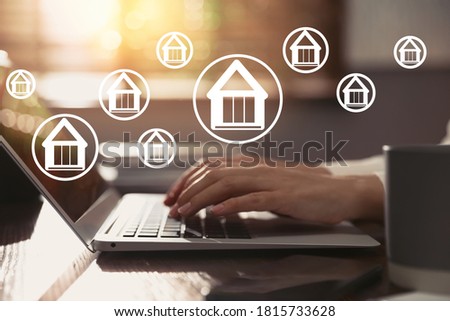 Property search concept. Woman using laptop at table, closeup