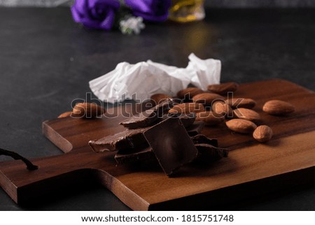Chocolate and Almonds on a black-toned wood floor