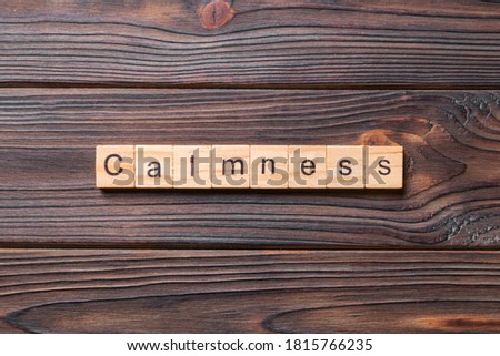 calmness word written on wood block. calmness text on cement table for your desing, concept.