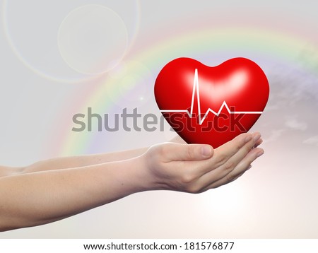 Concept conceptual 3D red human heart sign or symbol held in human man or woman hands, rainbow sky background, metaphor to health, care, medicine, protect, life, medical, pulse, healthcare cardiology