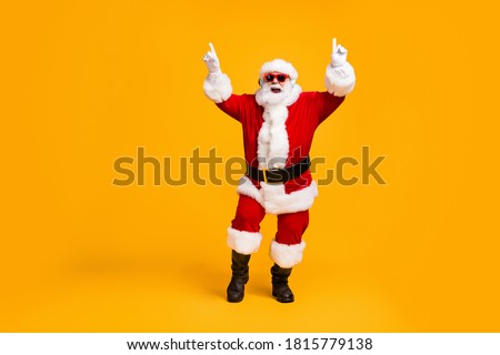 Full length photo of crazy santa claus with grey beard listen wireless modern headset x-mas christmas music dance party wear sunglass cap isolated bright shine color background