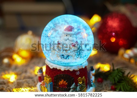 christmas ball with snow and santa claus and toys, bokeh, flatley, copyspace