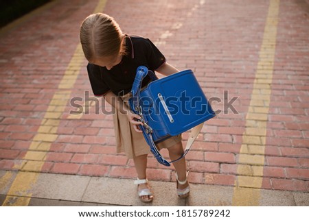 Back to school. Little girl from elementary school outdoor. Kid going learn new things 1th september