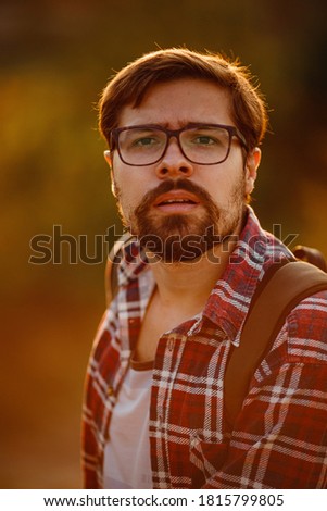 Young Man Traveler with backpack relaxing outdoor with rocky mountains on background. Lifestyle, and hobby concept
