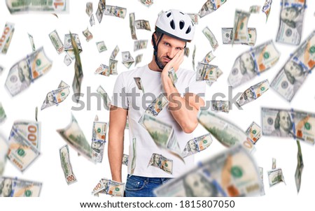 Young handsome man wearing bike helmet thinking looking tired and bored with depression problems with crossed arms.