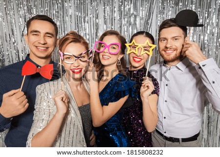 celebration, fun and holiday concept - happy friends posing with party props Royalty-Free Stock Photo #1815808232
