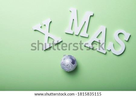 Christmas gift card with white letters on the green background. Holiday concept, top down view with copy space for text