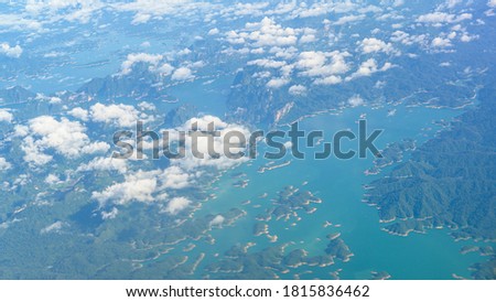 Aerial view photo from airplane of tropical island and turquoise clear ocean.